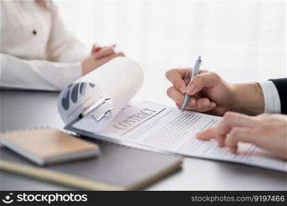 Closeup businessman sign contract or legal document with pen in his hand during corporate meeting for business deal or legal executive decision to pay off a loan or filing for bankruptcy. Equilibrium. Closeup businessman sign contract with a pen in his hand. Equilibrium