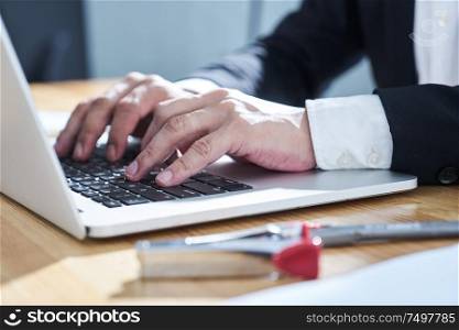 Closeup businessman using laptop to work .