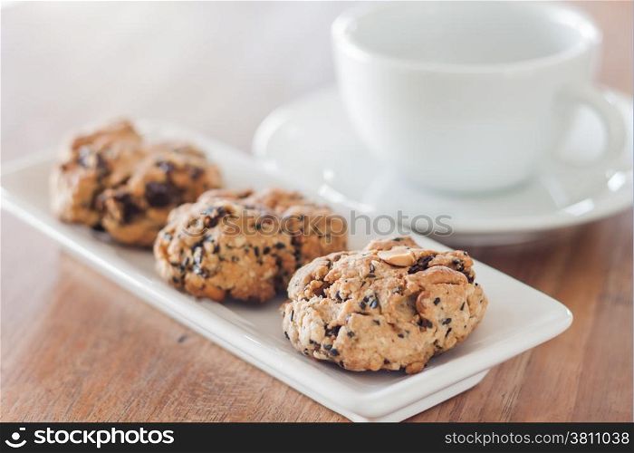 Closeup cereal cookies with coffee cup, stock photo