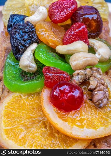 Closeup colorful fruitcake pasted with sweetend fruits.