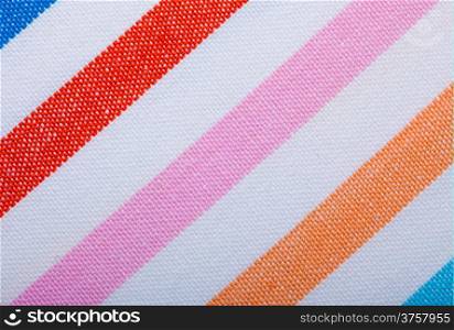 Closeup colorful striped fabric textile as background texture or diagonal stripe pattern. Macro.