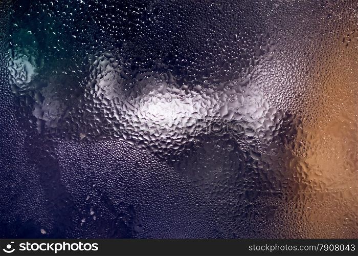 Closeup colorful texture of water condensing on glass surface