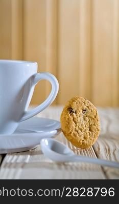 closeup composition. blue coffee cup with spoon and cookie
