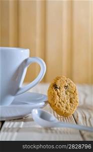 closeup composition. blue coffee cup with spoon and cookie