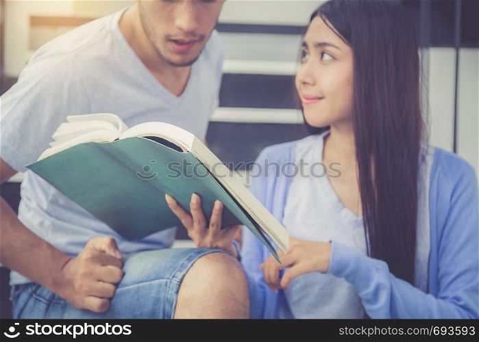 Closeup couple asian handsome man and beautiful woman reading book and glad at home, boyfriend and girlfriend with activities together for leisure, education success concept.
