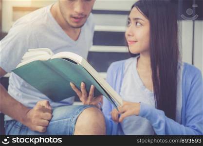 Closeup couple asian handsome man and beautiful woman reading book and glad at home, boyfriend and girlfriend with activities together for leisure, education success concept.