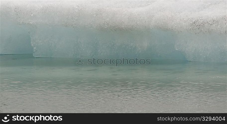 Closeup delicate melting iceberg at water&acute;s edge
