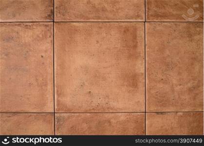 Closeup detail of a ocher stone tile wall background.