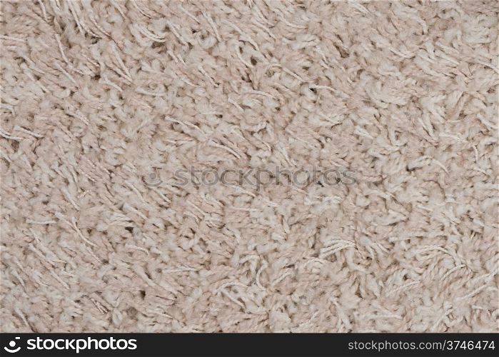 Closeup detail of beige carpet texture background.