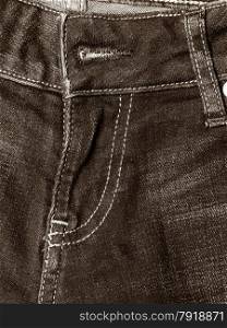 closeup detail of black denim jeans trouses zip, texture background
