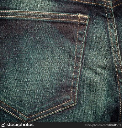 closeup detail of blue denim jeans trouses pocket, texture background