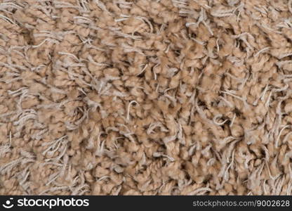 Closeup detail of brown carpet texture background.