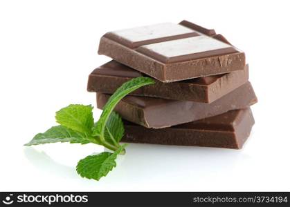 Closeup detail of chocolate parts and mint leaves on white background.