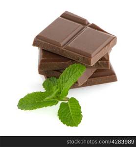 Closeup detail of chocolate parts and mint leaves on white background.