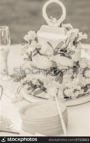 Closeup detail of white wedding cake at reception table