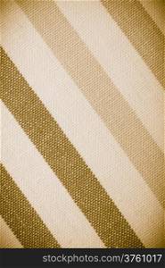 Closeup diagonal striped fabric textile sepia tone as background texture or pattern. Macro.