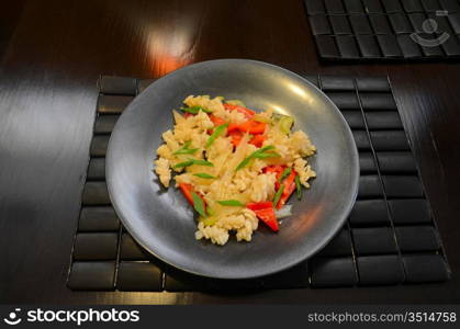 closeup dish of calamari with celery at black plate