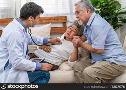 Closeup Doctor hand using stethoscope for auscultate Asian grandparent patient in house, service Life insurance at home, healthcare with Long live, Prevent epidemic and Covid19 Disease concept