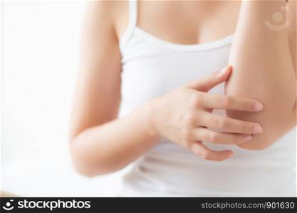 Closeup elbow of beautiful asian woman applying skincare and moisturizer cream or treatment for scratch and itchy, asia girl applying cream and lotion for dryness of skin care with cosmetic makeup.