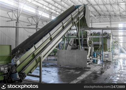 closeup escalator at the factory for processing and recycling of plastic bottles. PET recycling plant. a plant for recycling bottles