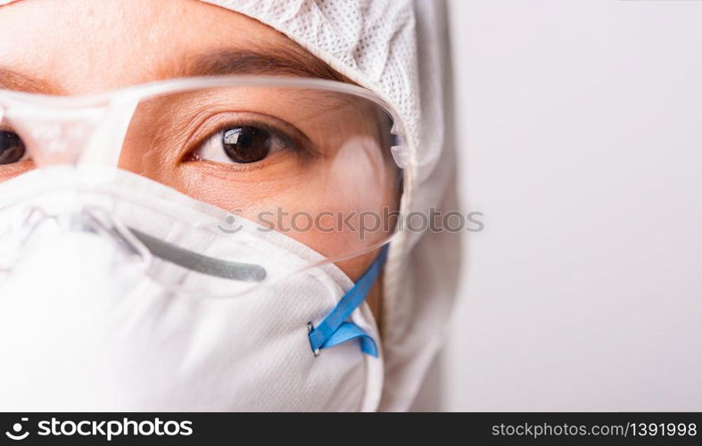 Closeup face of portrait woman doctor or scientist in PPE suite uniform wearing face mask N95 protective and eyeglasses in lab, coronavirus or COVID-19 concept isolated white background