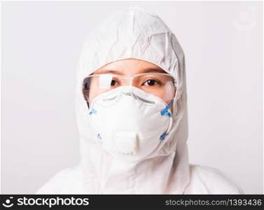 Closeup face of portrait woman doctor or scientist in PPE suite uniform wearing face mask N95 protective and eyeglasses in lab, coronavirus or COVID-19 concept isolated white background