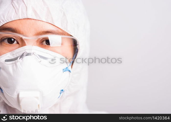 Closeup face of portrait woman doctor or scientist in PPE suite uniform wearing face mask N95 protective and eyeglasses in lab, coronavirus or COVID-19 concept isolated white background