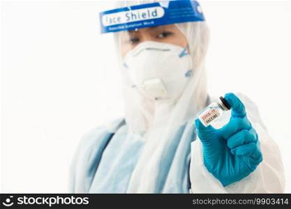 Closeup female medical scientist in PPE uniform wearing a face mask protective and plastic face shield holding Coronavirus  COVID-19  vaccine on hand isolated on white background