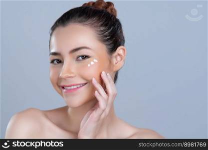 Closeup glamorous beautiful perfect clean skin soft makeup woman finger applying moisturizer cream on her face under contour eye for anti aging wrinkle. Facial skin rejuvenation in isolated background. Closeup glamorous woman applying moisturizer cream on her face for perfect skin