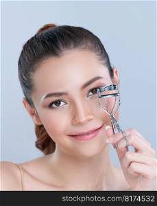 Closeup glamorous facial makeup, beautiful woman with perfect smooth cosmetic clean skin correct eyelash curler with metal mechanic beauty accessory in isolated background.. Closeup glamorous woman correct eyelash curler with alluring facial makeup