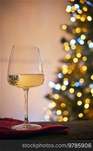 Closeup Glass of White Wine and Christmas Tree Lights