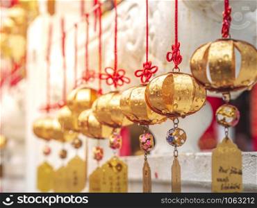 Closeup Golden wishing bells at Sun Moon Lake Wenwu Temple with yellow sunlight.
