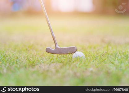 Closeup golf club and a white golf ball in the grass ready to the driver in tournament, outdoor sport