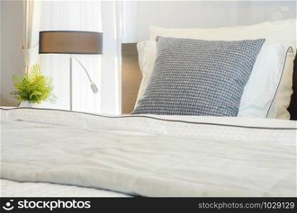 Closeup gray pillow on bed with modern classic style bedding