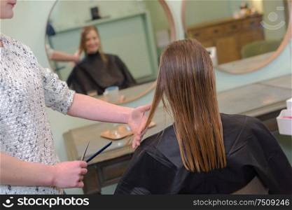 closeup hairdresser coiffeur makes hairstyle
