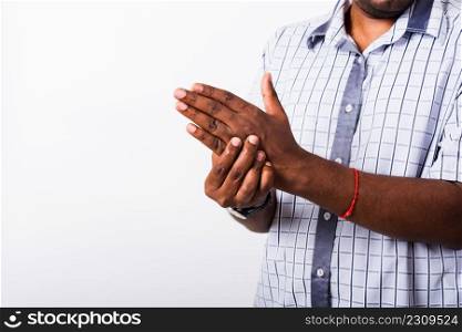Closeup hand Asian black man holds his palm hand injury, feeling pain, studio shot isolated on white background. Health care and medical office syndrome concept