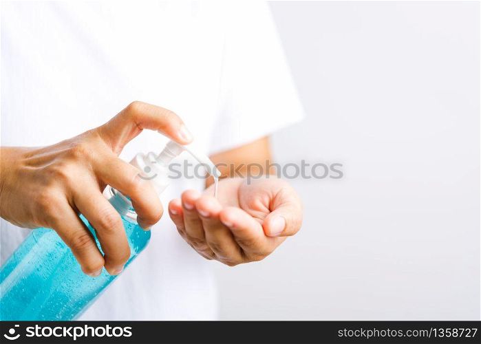 Closeup Hand Asian young woman applying pump dispenser sanitizer alcohol gel on hand wash cleaning, hygiene prevention COVID-19 or coronavirus protection concept, isolated on white background