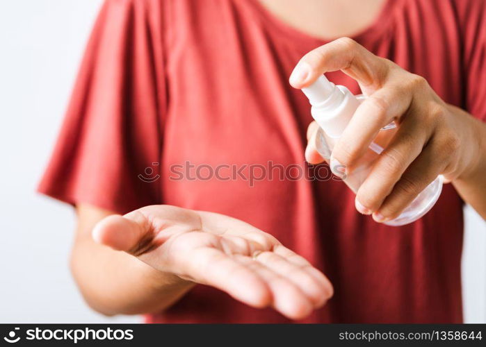 Closeup Hand Asian young woman applying spray pump dispenser sanitizer alcohol on hand wash cleaning, hygiene prevention COVID-19 or coronavirus protection concept, isolated on white background