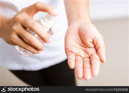 Closeup Hand Asian young woman applying spray pump dispenser sanitizer alcohol on hand wash cleaning, hygiene prevention COVID-19 or coronavirus protection concept, isolated on white background