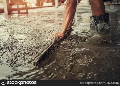 closeup hand of worker plastering cement for building house in concstruction site