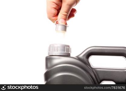 Closeup hand opening canister with car engine oil white background