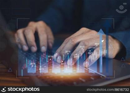 Closeup hand using computer trading online on digital chart visual screen technology