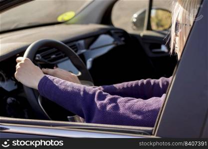 Closeup hands of woman,hand pushing on steering wheel honking horn, on the road,female driver concept