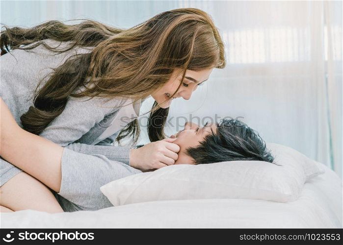 Closeup Happy Asian Lover kissing and hugging on the bed in bedroom at modern home, Couple and life style concept,
