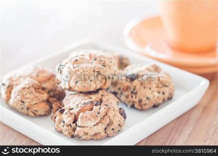 Closeup healthy cookies on white plate with coffee cup, stock photo