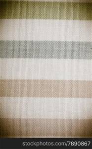 Closeup horizontal striped fabric textile sepia tone as background texture or pattern, vignette. Macro.