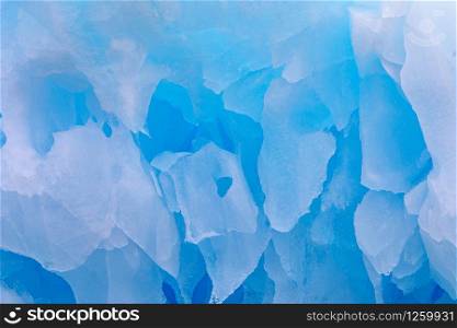 Closeup ice crystals hanging in blue color from ceiling in glacier cave near south pole