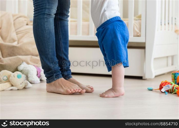 Closeup image of 10 months old baby boy making first steps