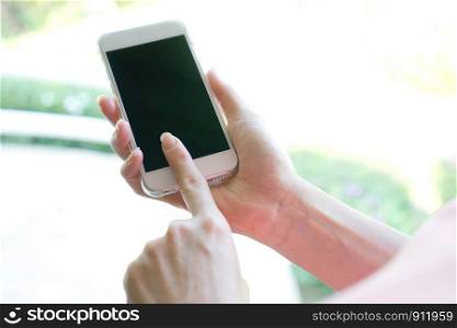 Closeup image of a female hands using smartphone