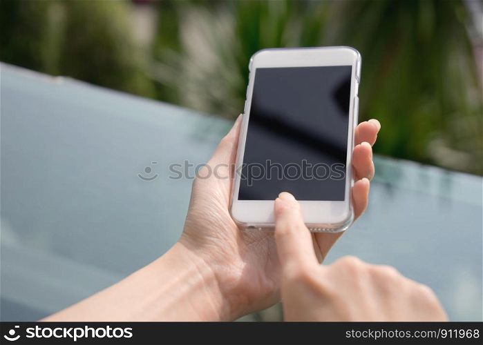 Closeup image of a female hands using smartphone